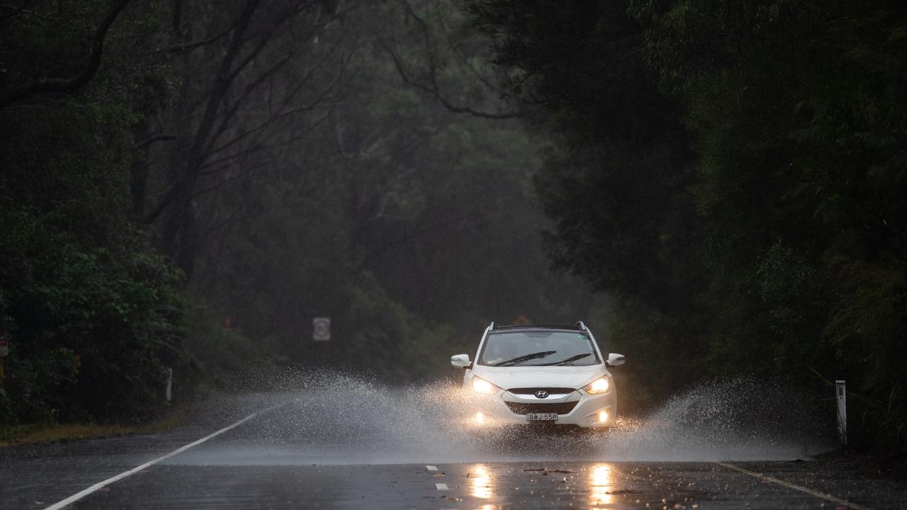 Generic scenes on The Northern Beaches on 20th March 2021 as the forecast 'rain bomb' of wet weather hits Sydney. Cars driving through rainwater on The Wakehurst Parkway just before the section of the road that was closed. (Pictures by Julian Andrews).