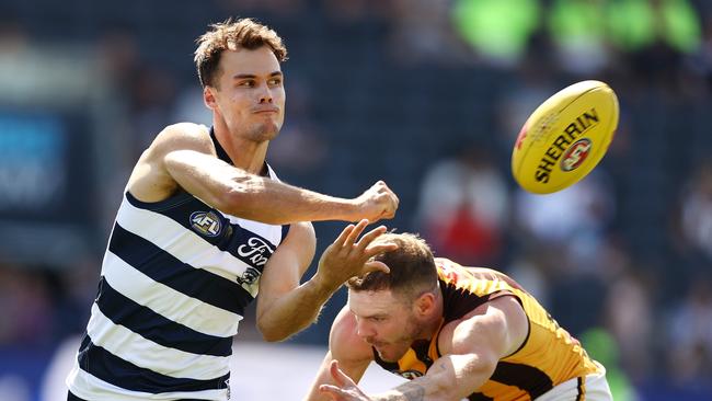 MELBOURNE . 23/02/2023. AFL . Geelong vs Hawthorn at Kardinia Park, Geelong. Jack Bowes of the Cats clears by hand during the 1st qtr. . Pic: Michael Klein