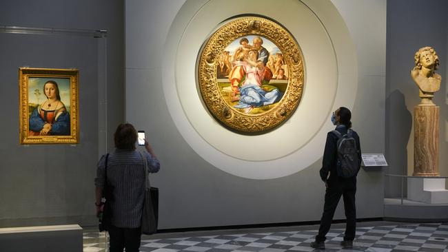 People admire 15th century painting "Doni Tondo" by Michelangelo Buonarroti, during a press tour of the Uffizi museum on the day off its reopening in Florence. Picture: AP