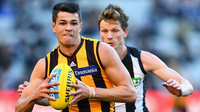 Star in the making ... Hawthorn young gun Ryan Burton is chased by Collingwood’s Will Hoskin-Elliott. Picture: Quinn Rooney (Getty Images)