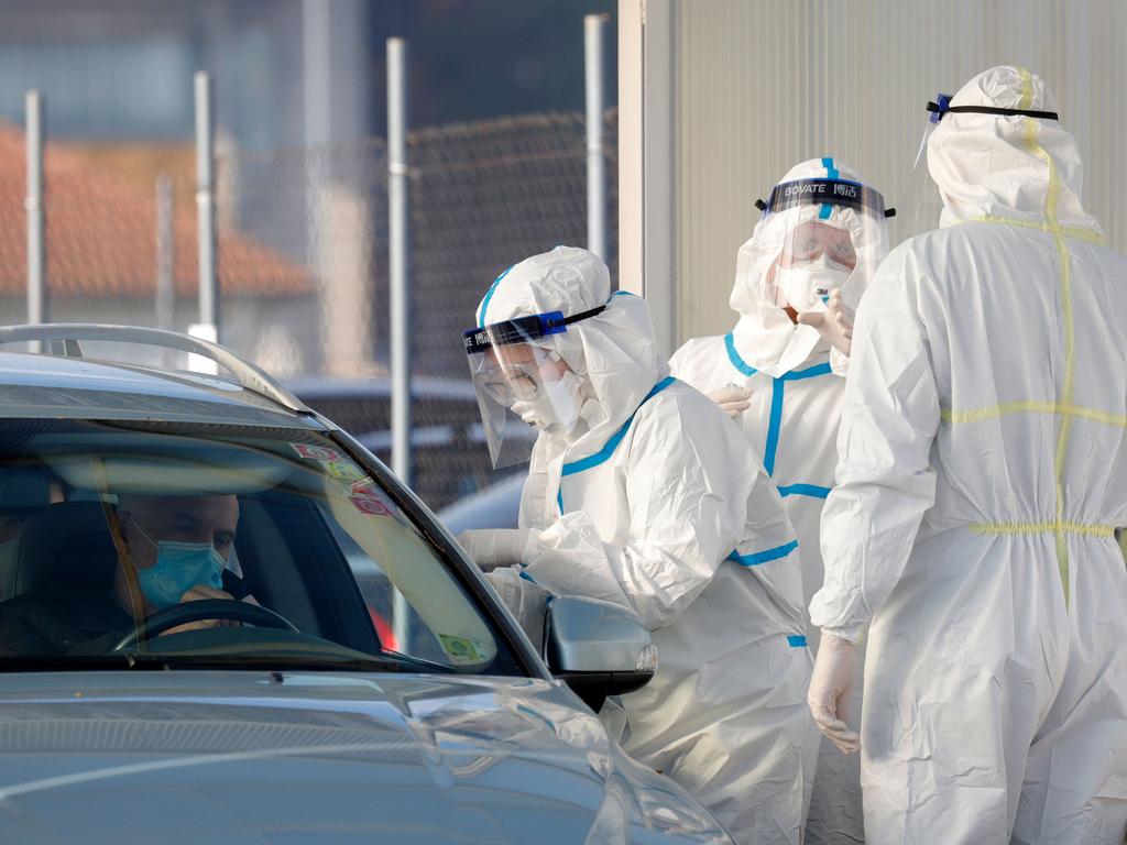 Medical staff in personal protective equipment (PPE) test people for coronavirus. Picture: Denis Lovrovic/AFP