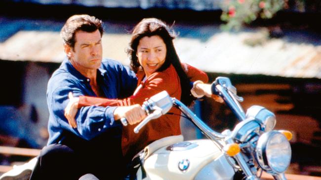 With co-star Pierce Brosnan in Tomorrow Never Dies.