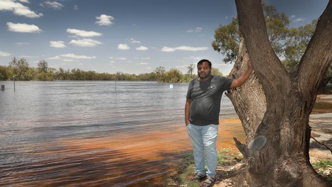 Satish Tati on the banks of the rising River Murray. Picture Dean Martin