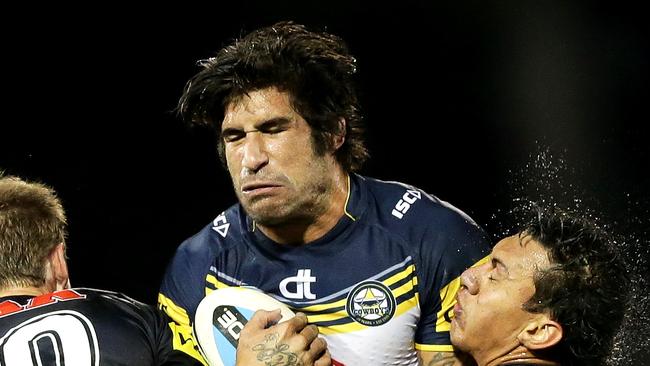 James Tamou is tackled by Jeremy Latimore and Sika Manu of the Panthers.