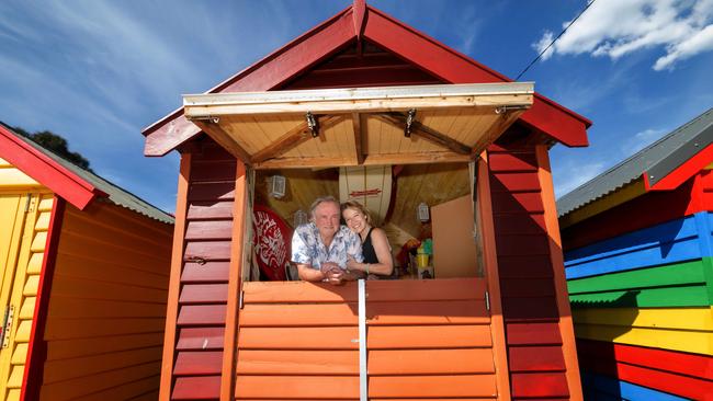 The Brighton Bathing Box Association's secretary John Rundell and wife Sonia Castelli own a box painted in red and orange. Picture: Tony Gough