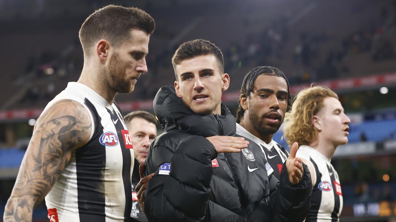 MELBOURNE, AUSTRALIA - AUGUST 05: Nick Daicos of the Magpies (C) walks off the field with Jeremy Howe (L) and Isaac Quaynor of the Magpies (2R) as Magpies head coach Craig McRae (L2) looks on during the round 21 AFL match between Hawthorn Hawks and Collingwood Magpies at Melbourne Cricket Ground, on August 05, 2023, in Melbourne, Australia. (Photo by Daniel Pockett/Getty Images)