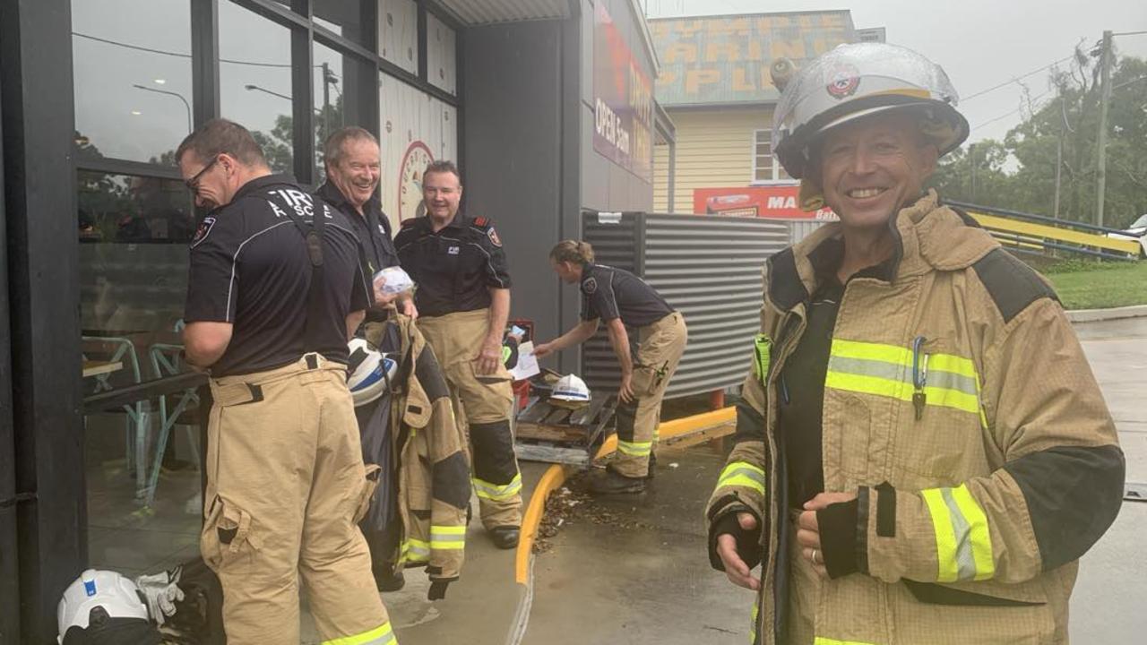 Gympie fire fighters including James Tomlinson (right) finish testing the air inside Toucan Coffee for any toxic fumes after fire broke out in a coffee machine on Tuesday.