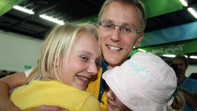 50km walk silver medallist Jared Tallent gets a hug from sister Rachel, 15, in Beijing.