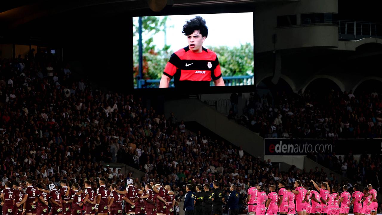 Players hold a minute of silence in tribute of Medhi Narjissi (screen) who disappeared at sea during an internship with the French junior rugby team ahead of the French Top14 rugby union match between Union Bordeaux-Begles (UBB) and Stade Francais Paris at The Chaban-Delmas Stadium in Bordeaux, south-western France on September 7, 2024. (Photo by ROMAIN PERROCHEAU / AFP)