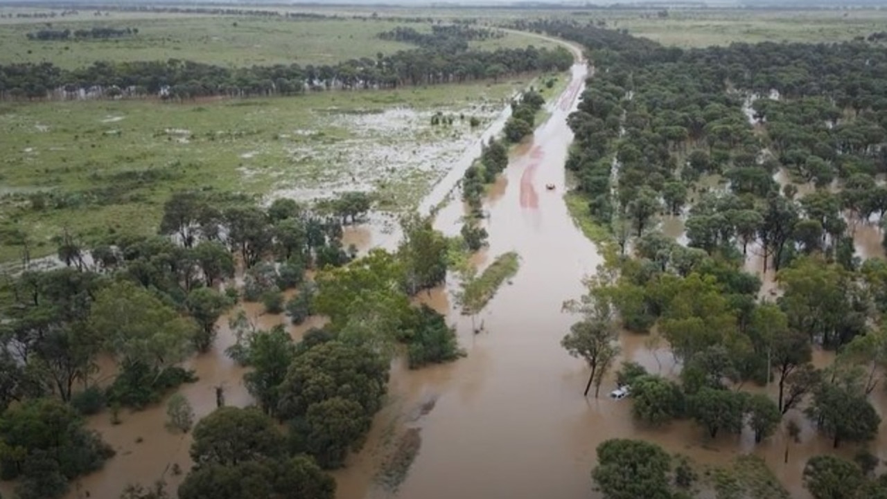 Swift water rescue crews rescued a driver stranded on his ute's roof after his vehicle was swept of the roadway at Balyendo crossing. Image: QFD