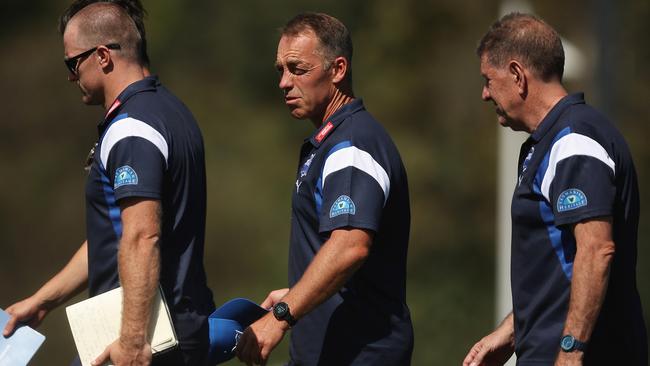 Alastair Clarkson (centre) has been fined $20,000 after an expletive-laden tirade against St Kilda’s Jimmy Webster during a pre-season match. Picture: Daniel Pockett / Getty Images