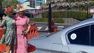 Cr Capp (right) arrives by limo at the 2023 Melbourne Cup.