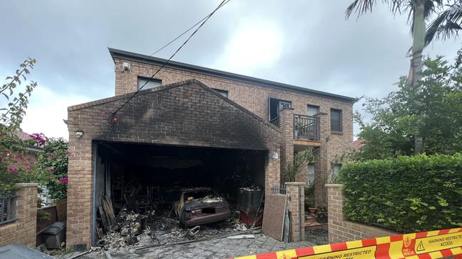 The home was significantly damaged, with a car in the garage completely destroyed. Picture: FRNSW