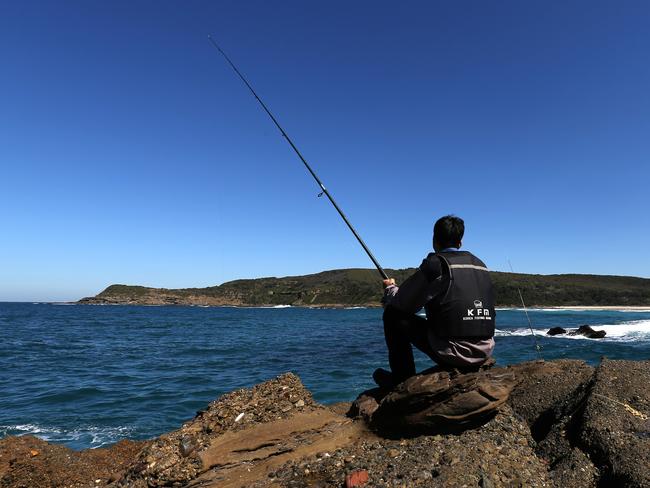 A man fishes close to the edge of the rocks at Snapper Point, one of the Coast’s most notorious rock fishing danger zones. Picture: Ashley Feder