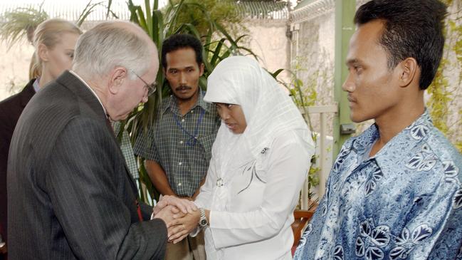 Survivors and victims of the Australian Embassy bombing look on as Prime Minister John Howard comforts a woman whose husband died in the 2004 attack in Jakarta. Picture: Michael Jones/Commonwealth of Australia