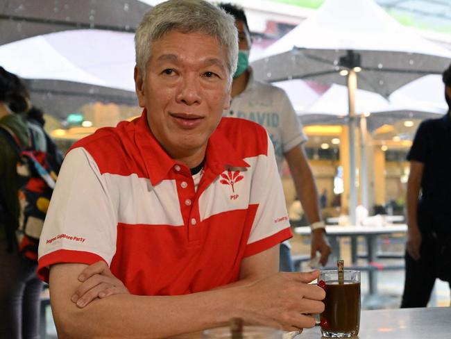 (FILES) Lee Hsien Yang, the brother of Singapore's then prime minister Lee Hsien Loong and son of the city state's founding father Lee Kuan Yew sits for a coffee after being presented membership to the opposition Progress Singapore Party during an event at the Tiong Bahru Market in Singapore on June 24, 2020. A bungalow where Singapore's early leaders spent long hours to lay the country's foundations is under the spotlight as a bitter feud rages between former prime minister Lee Kuan Yew's children. (Photo by ROSLAN RAHMAN / AFP)