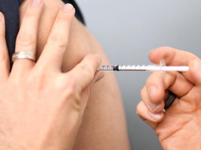 BRISBANE, AUSTRALIA - NewsWire Photos - AUGUST 8, 2021. A young man receives the AstraZeneca Covid-19 vaccine by pharmacist Michael Thorp at the Carina Day and Night pharmacy in Brisbane. Picture: NCA NewsWire / Dan Peled