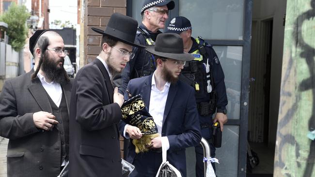 Synagogue members remove religious material from Adass Israel synagogue after it was fire-bombed. Picture: NewsWire /Andrew Henshaw