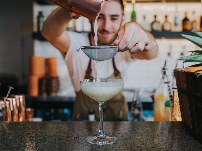 The Collective Palm Beach staff straining and making cocktail drink. Picture: Supplied/Destination Gold Coast