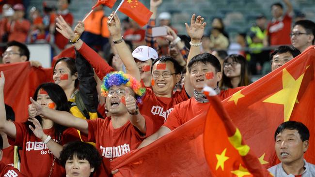 Fans of China cheer during their Group B football match against North Korea in the AFC Asian Cup in Canberra on January 18, 2015. AFP PHOTO/Peter PARKS --IMAGE RESTRICTED TO EDITORIAL USE - STRICTLY NO COMMERCIAL USE