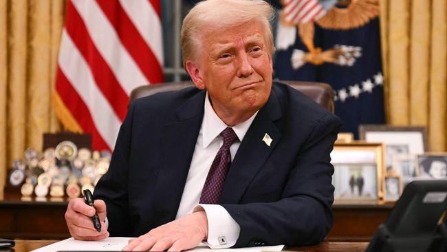 US President Donald Trump signs executive orders in the Oval Office of the White House in Washington, DC, on Tuesday. Picture: AFP