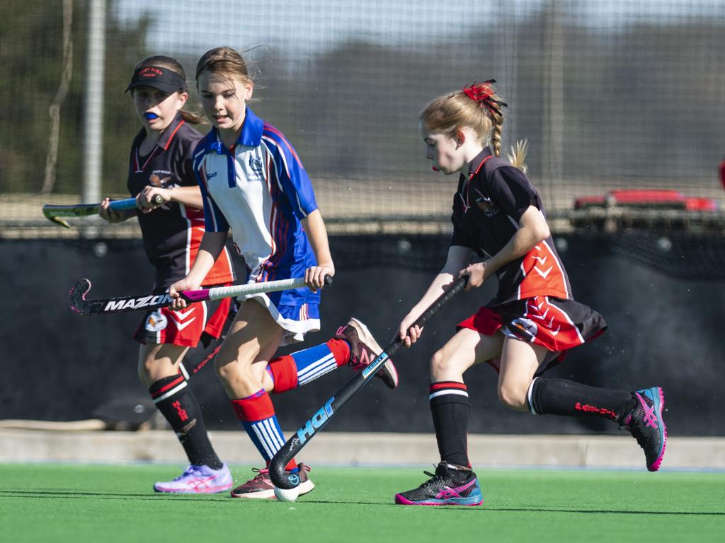 Mikayla Brasher (left) and Mali Robertson of Past High under pressure from Rangeville captain Amarni Jackson in under-11 girls Presidents Cup hockey at Clyde Park, Saturday, May 27, 2023. Picture: Kevin Farmer