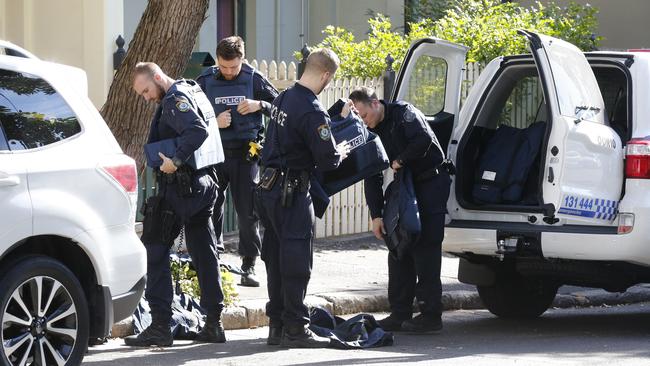 Police pictured putting on armoured vests. Picture: David Swift