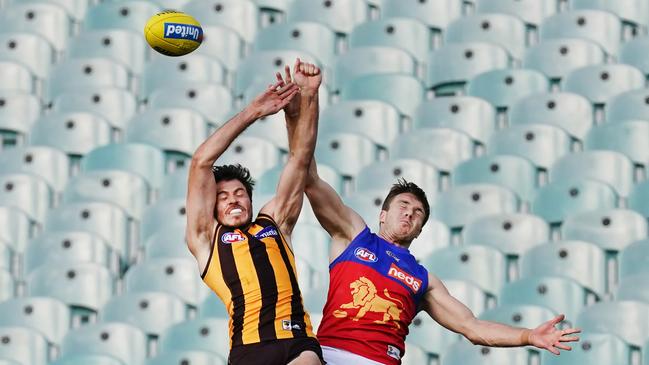 Isaac Smith competes for the ball against Lincoln McCarthy in front of empty seats during Round 1 at the MCG. Picture: AAP