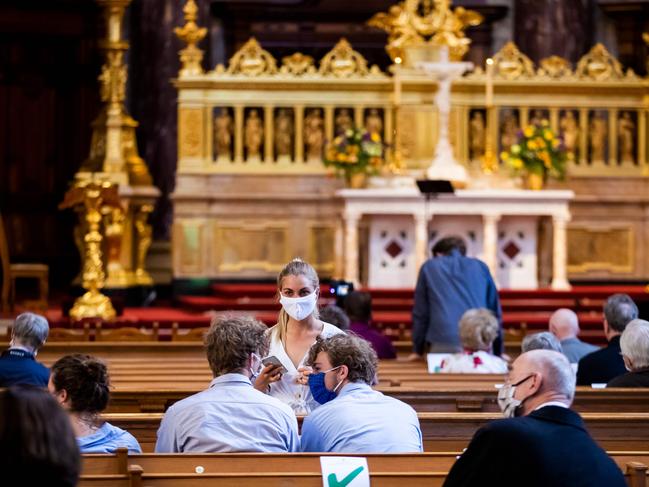 Members of the congregation wear face masks and observe social during a Sunday service at the Berliner Dom cathedral in Berlin. Picture: AFP