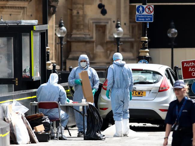 Forensic officers with the vehicle that crashed into security barriers, injuring a number of pedestrians. Picture: Getty Images