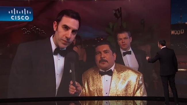 Matt Damon photobombs Sacha Baron Cohen as he's interviewed on the red carpet. Picture: Jimmy Kimmel Live