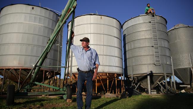 Stuart Hackney and his son Mitchell next to silos that are in the path of the proposed transmission lines on their Dunedoo property. Pic By Dean Marzolla