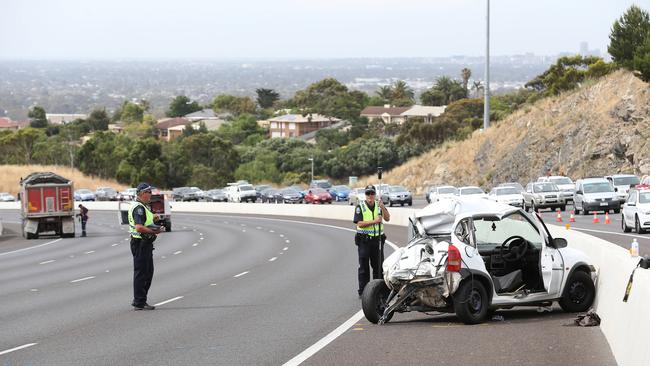 Police at the scene of the crash on the Southern Expressway. Picture: Stephen Laffer