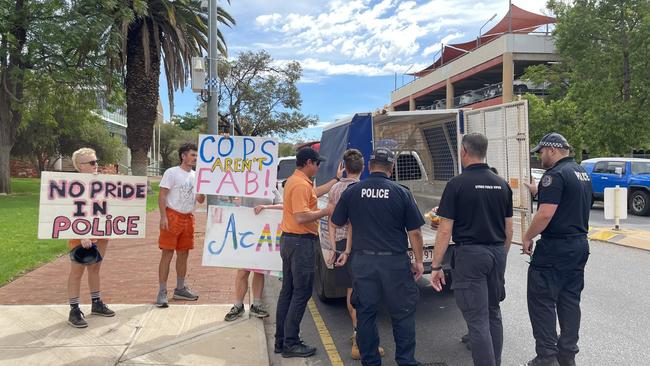 A protester is arrested during a rainbow flag-raising ceremony out the front of the Alice Springs police station. Image: DANIEL WOOD