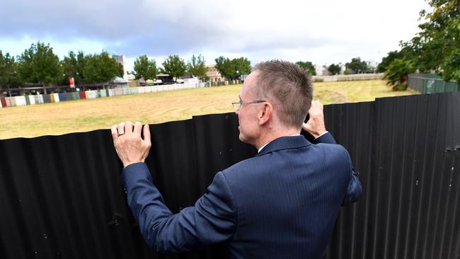 Lord Mayor Martin Haese looks over the fence after the announcement of the purchase of the former Le Cornu site in North Adelaide. Picture: AAP / David Mariuz