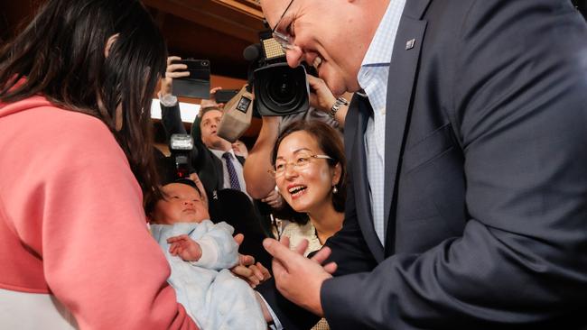 Prime Minister Scott Morrison meets his first baby of the election campaign, 35-day-old boy Muxi Luo. Picture: Jason Edwards