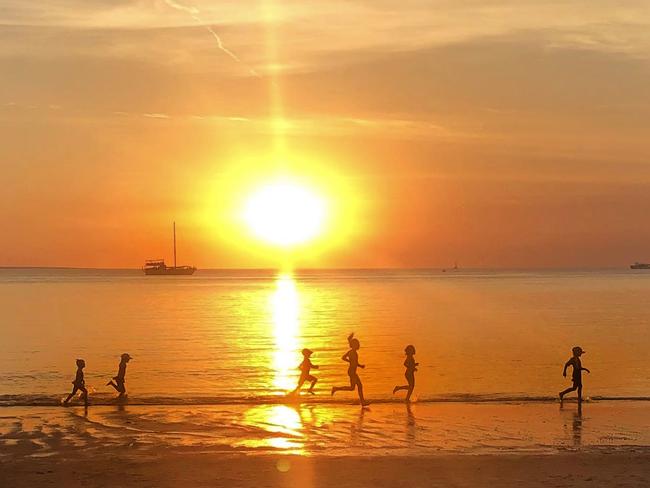 Children make the most of the evening sun at Mindil Beach. Picture: Kristy Cunningham