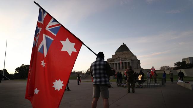 Dozens of police surround the Shrine to deter anti-mask protesters. Picture: Getty