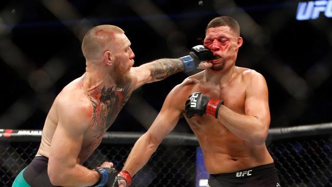 Conor McGregor hits Nate Diaz with a left during their welterweight rematch at the UFC 202 event.