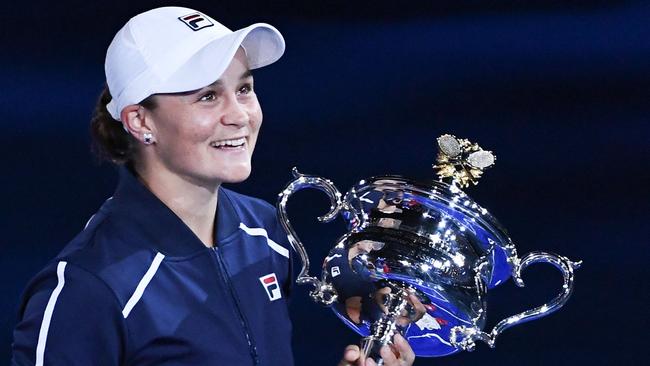 Australia's Ashleigh Barty holds the trophy after winning against Danielle Collins of the US during their women's singles final match on day thirteen of the Australian Open tennis tournament in Melbourne on January 29, 2022. (Photo by William WEST / AFP) / -- IMAGE RESTRICTED TO EDITORIAL USE - STRICTLY NO COMMERCIAL USE --