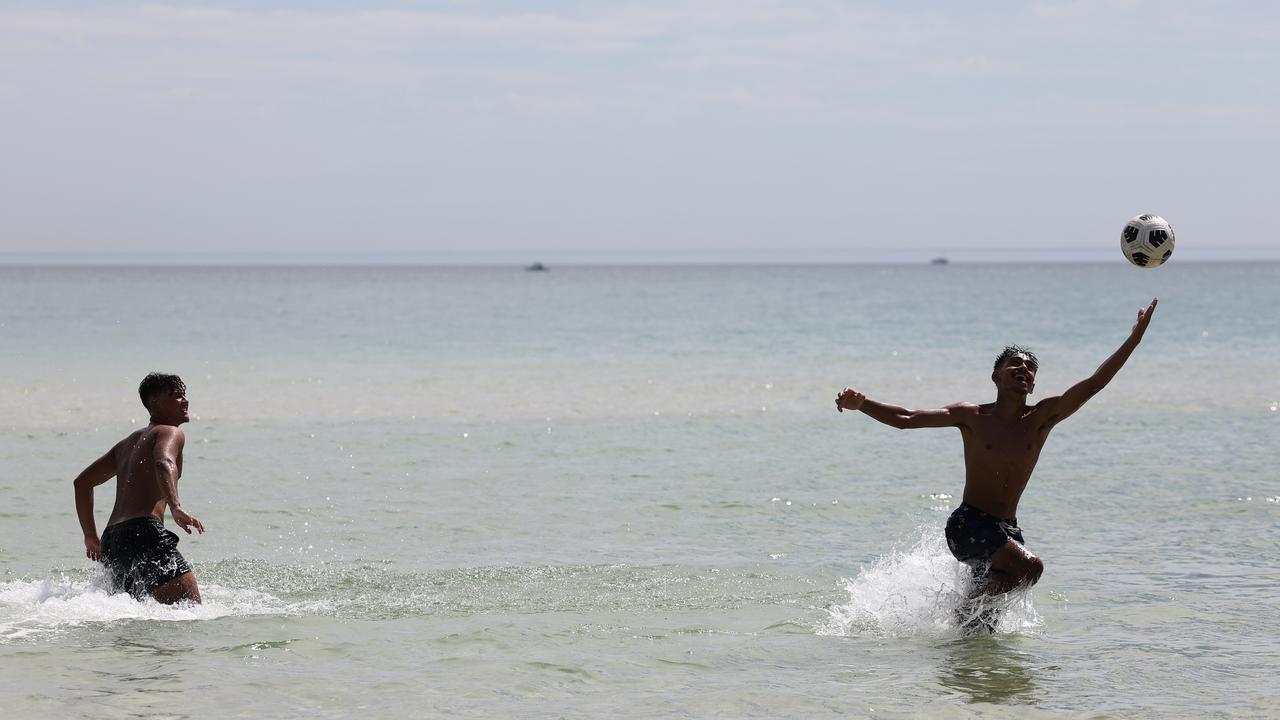 Beach-goers enjoy the water at West Beach on a hot day in Adelaide. NCA NewsWire / David Mariuz