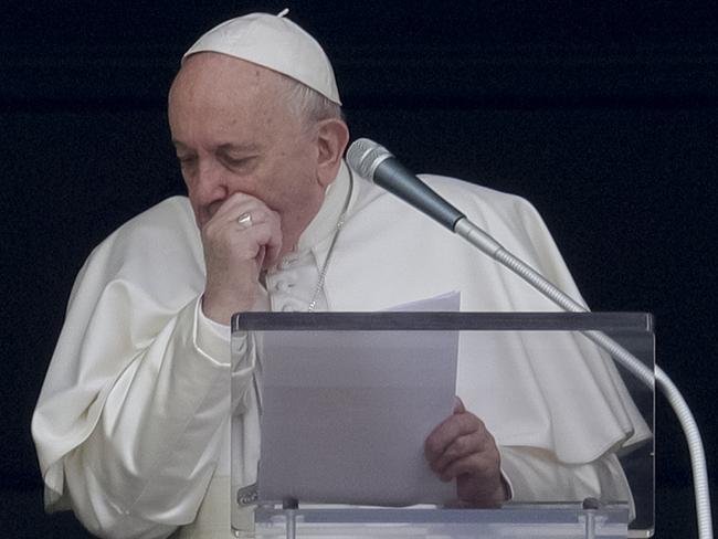 Pope Francis coughs during the Angelus noon prayer he recited from the window of his studio overlooking St. Peter's Square, at the Vatican. Picture: AP