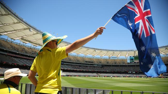 PERTH, AUSTRALIA - DECEMBER 17: Aussie Fan waves the Australian flag during day four of the Men's First Test match between Australia and Pakistan at Optus Stadium on December 17, 2023 in Perth, Australia (Photo by James Worsfold - CA/Cricket Australia via Getty Images)