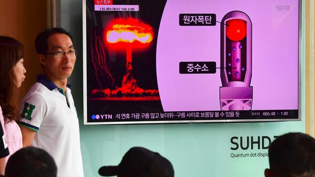 People watch a television news report on North Korea's latest nuclear test at a railway station in Seoul. Picture: AFP.