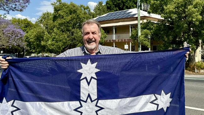 Ipswich City councillor Paul Tully with the Queensland flag outside the Royal Mail Hotel says the King’s Birthday Holiday should be replaced with Environment Day. Picture: Contributed