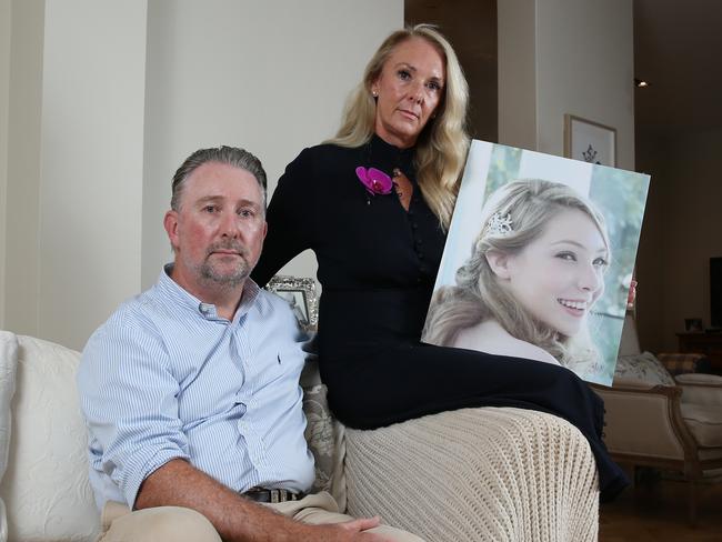 23/03/2023. Sophie and Bruce Sedgwick with their son Hunter and a photograph of their 23-year-old daughter Amy Sedgwick who died after receiving her Pfizer vaccinations last year. Photographed in Cremorne Point, Sydney. Britta Campion / The Australian