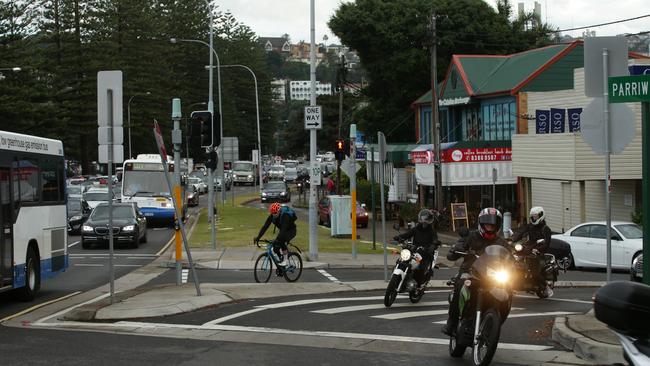 A cyclist uses the one-way lane while several motorbike riders pass through the open boom gate towards Parriwi Rd during morning peak hour earlier this month. Picture: Annika Enderborg