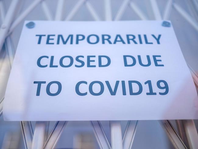 (FILES) In this file photo taken on June 01, 2020 A sign is seen in the window of a shop explaining to customers that it has temporarily closed due to the coronavirus outbreak in Portobello Market in west London, following the easing of the lockdown restrictions during the novel coronavirus pandemic. - Electoral success, Brexit, a global health crisis that left him near death, divorce, engagement and even a new baby. Boris Johnson has had an eventful 12 months in anyone's book. Johnson, 56, marks his first anniversary as Britain's prime minister on Friday, having had what one lawmaker described to the Guardian newspaper as a "hell of a year". But his toughest test could yet be to come, as the full impact of the coronavirus outbreak bites on the UK economy, which has been battered by three months of enforced shutdown. (Photo by Tolga AKMEN / AFP)