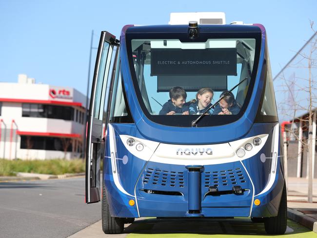 TICKET TO RIDE: Glen Osmond Primary students Xavier, Elsa and Livia test a driverless shuttle bus at Tonsley, after a survey found most parents are worried about the safety of the technology. Picture: TAIT SCHMAAL