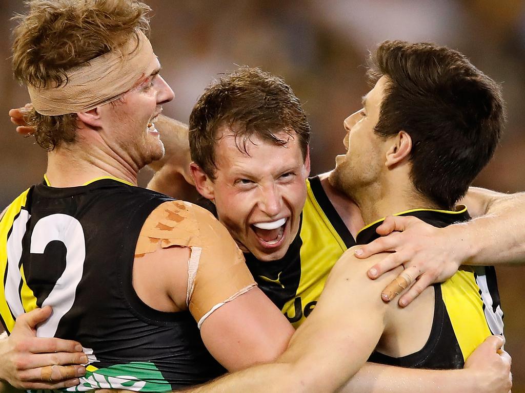 MELBOURNE, AUSTRALIA - SEPTEMBER 23: (L-R) David Astbury, Dylan Grimes and Trent Cotchin of the Tigers celebrate during the 2017 AFL Second Preliminary Final match between the Richmond Tigers and the GWS Giants at the Melbourne Cricket Ground on September 23, 2017 in Melbourne, Australia. (Photo by Adam Trafford/AFL Media/Getty Images)